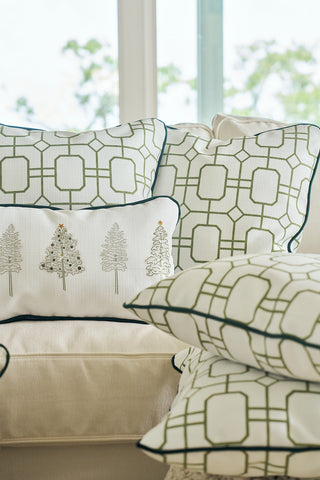 The Green Holiday Lattice Oversized Pillow adds festive holiday decor to a beige sofa in a bright room with large windows.