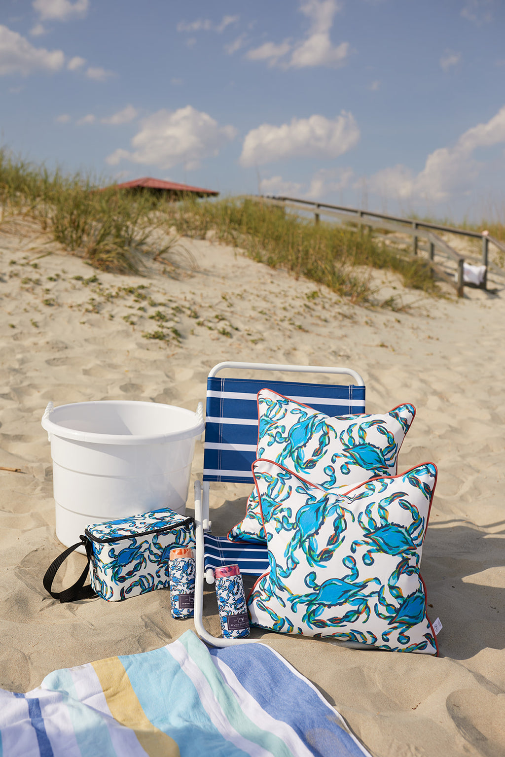 The Crab Craze, Shades of Blue Outdoor Pillow showcases a playful pattern of blue crabs with swirling accents on a light pink background. Decorated with red edging and made from SDS Shield® Outdoor Fabric, its ideal for adding coastal flair to indoor or outdoor spaces.