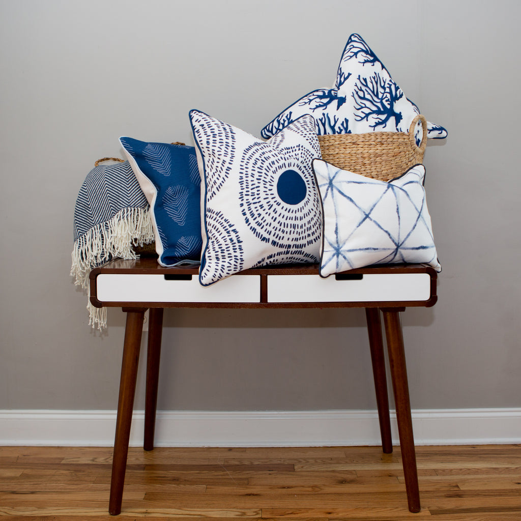 The Navy Medallion Oversized Pillow features a white background with a navy blue abstract circular pattern, inspired by Sewing Down South™, adding coastal chic style to any room.