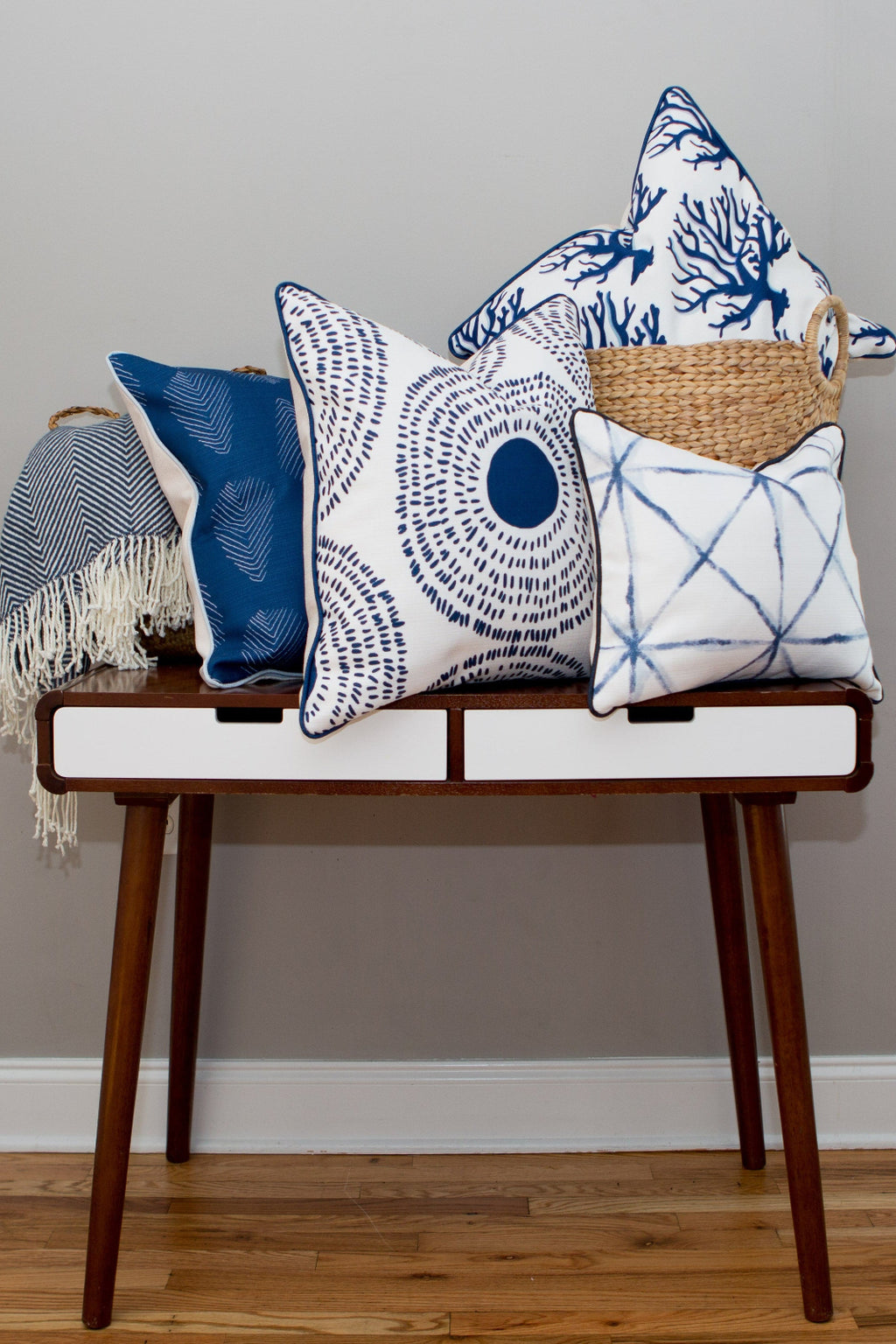 The Navy Medallion Oversized Pillow features a white background with a navy blue abstract circular pattern, inspired by Sewing Down South™, adding coastal chic style to any room.