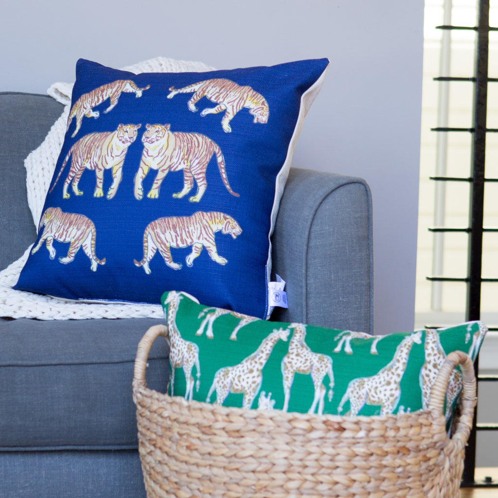 The Giraffes on Grass Lumbar Pillow, a green rectangle, features two symmetrically positioned giraffes facing each other. This captivating design adds an exotic flair to any space.
