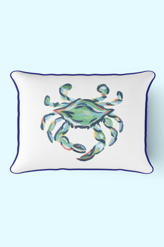 The Outdoor King Crab Lumbar Pillow with Navy showcases a watercolor-style crab in green and blue on a light blue background. Featuring dark edge piping, its crafted from SDS Shield® Outdoor Fabric, blending durability and style in this Sewing Down South™ design.