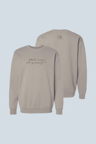 Two light gray WWWMS Embroidered Script Crewneck Sweatshirts are shown on a pale blue background, one with "What's wrong with my sewing?" on the front and the other featuring a small circular logo—a Bravocon exclusive.