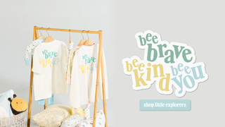 Clothing rack featuring t-shirts with "Bee Brave. Bee Kind. Bee You." design on them. Button that reads "Shop Little Explorers"