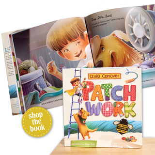 The book 'Patch Work' by Craig Conover is displayed in front of its illustrated open back cover, with a yellow 'shop the book' badge in the lower left. The book cover features a colorful, playful design with a dog, a ladder, and a bee, and is set against a light wood tabletop background.