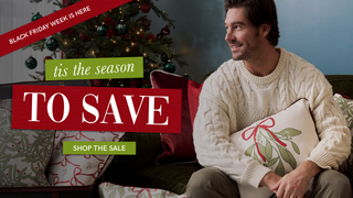 Man sitting on a couch with a Christmas tree in the background, promotional text overlay for Black Friday sale.