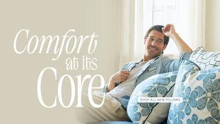 Craig relaxing on a couch with pillows, text 'Comfort at its Core' and 'Shop All New Pillows'.