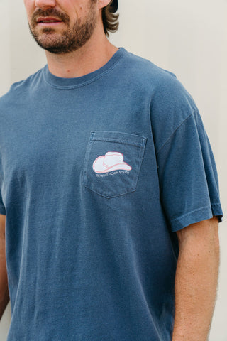 A man wears a faded blue 'Life is Better in Sew Country' Tee—a unisex shirt with a chest pocket and white cowboy hat graphic. The text SEWING DOWN SOUTH is visible. Only his lower face and upper torso are shown.
