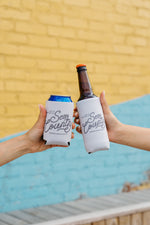 Pair of tan koozies reading "Life is better in Sew Country. Sewing Down South" featuring a rope design font, printed in brown ink 