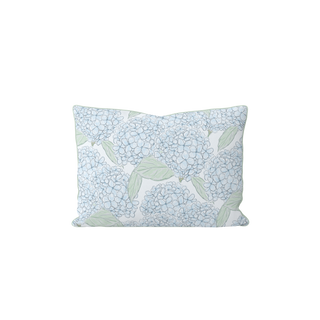 The Hydrangeas All Over Lumbar Pillow features a hand-painted light blue and green hydrangea floral pattern on a white background, and is made in the USA.