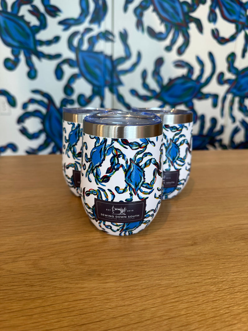 The Crab Craze Beach Towel + Wine Tumbler Bundle features three insulated tumblers with blue crab designs alongside the matching beach towel, creating a colorful, coordinated set for Sewing Down South fans.