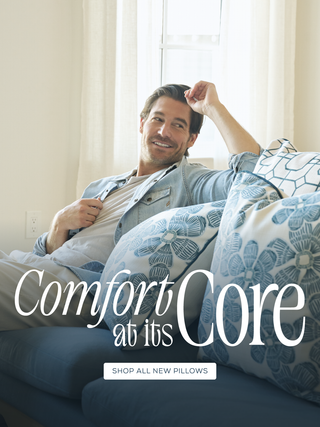 Craig relaxing on a couch with decorative pillows, text 'Comfort at its Core' displayed.