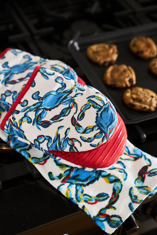 Crab Craze takes over the kitchen with colorful Crab Craze Mini Oven Mitts featuring silicone grips on the stovetop, while a baking tray brims with cookies in this lively, ocean-themed culinary haven.