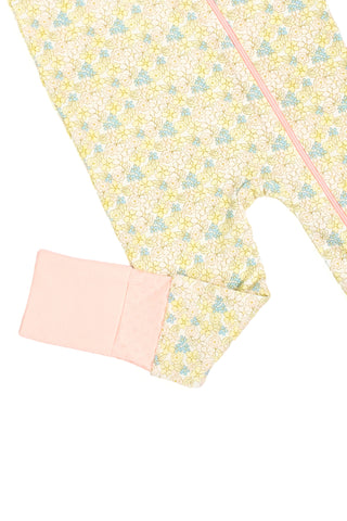 Precious Petals Dream & Play Zipper Romper features a pastel floral print, easy zipper, and folded sleeve with a textured light pink cuff. Made from cotton modal; perfect baby sleepwear against a white background.