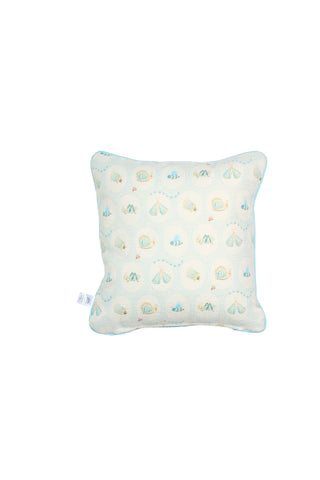 The Buggin’ Out Children’s Pillow is a square cream pillow with a light blue and yellow seashell pattern and a small white tag on the side.