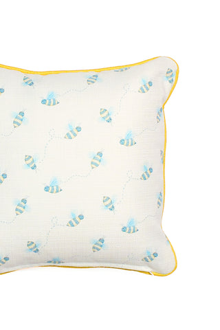 The Buzzin’ Around Children’s Pillow features a white cover with blue and yellow bees, dotted flight paths, and yellow piping—ideal as a charming nursery or playful children’s decor accent.