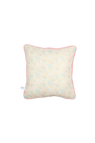 Precious Petals Children’s Pillow is a square decorative pillow featuring a pastel floral pattern and pink piping along the edges, displayed on a white background. This pillow offers double-sided prints for versatile styling, with a small white tag attached to one side.
