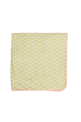 The Precious Petals Children’s Blanket features a small floral pattern in yellow and green on both sides for added versatility, with a folded design, light pink trim along the edges, and a white background.