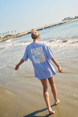 Woman walking on the beach in SDS tee
