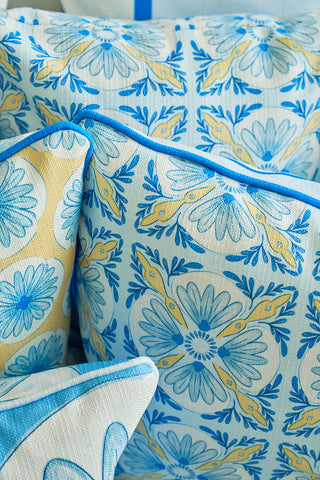 A close-up of the Euro Blue Tiles with Spring Blue Stripe Pillow, featuring vibrant blue, yellow, and white floral and geometric patterns, stacked for a cozy arrangement that evokes European charm and intricate tile designs.
