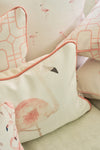 Close-up of decorative throw pillows, including The Flamingo Lumbar Pillow featuring soft pink piping and geometric patterns, arranged on a light sofa for a touch of tropical cheer—an exclusive Sewing Down South design.