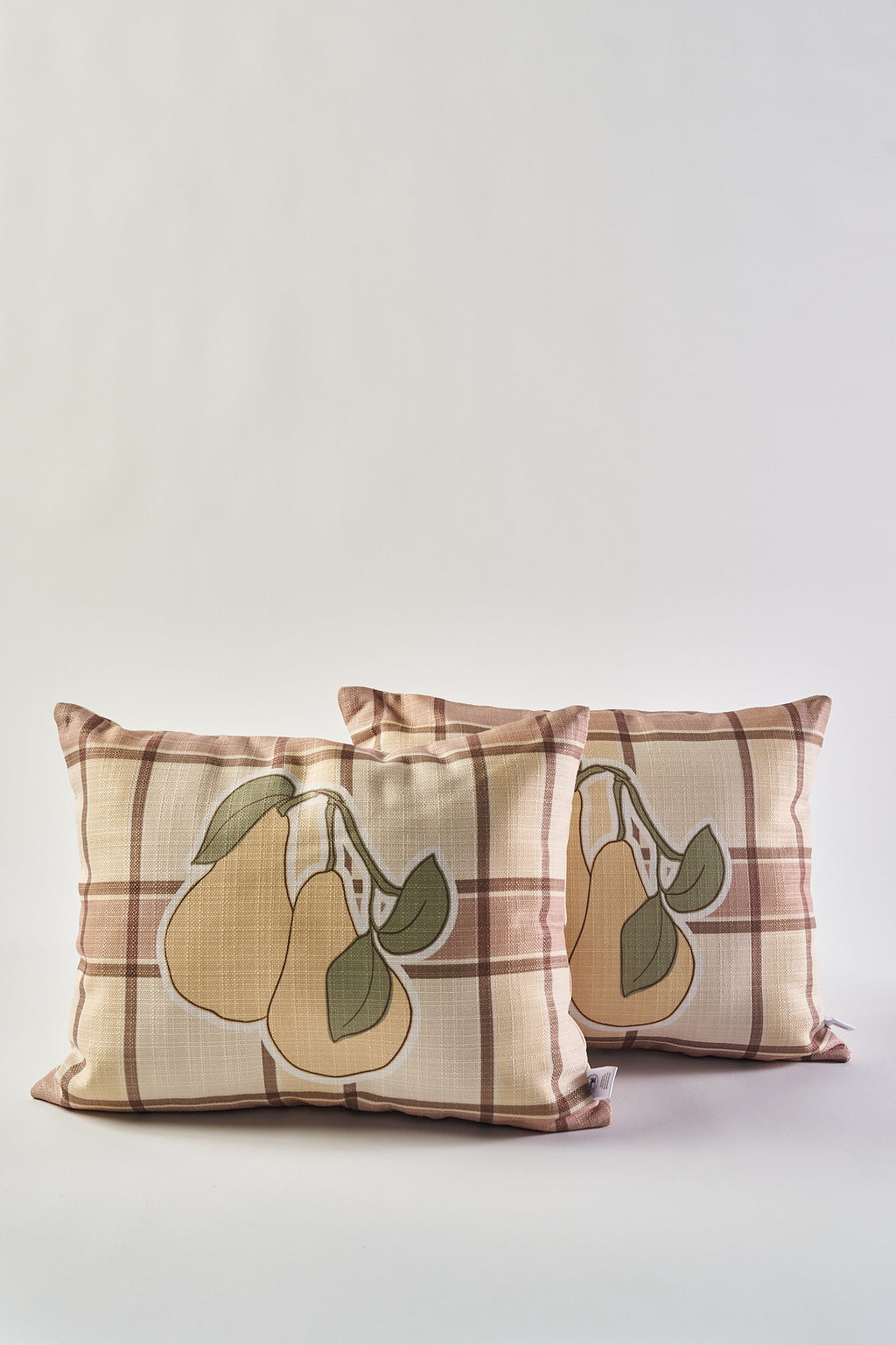 Add cozy autumn charm to your home with the 2 for $49.99 Fall Pears on Tartan Plaid Lumbar Pillow set—two plaid pillows featuring a pear motif and green leaves, perfect for seasonal decor against any neutral background.