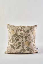The Fall Florals Pillow, a square pillow with a beige background, displays a green, yellow, brown, and white floral and fruit pattern—making it an ideal rustic accent when placed against a plain white backdrop.