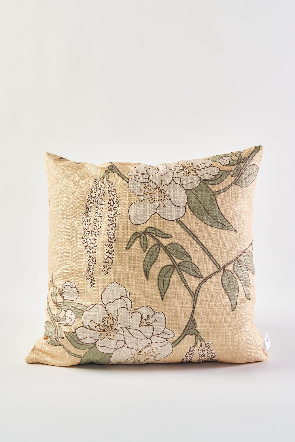 The Fall Pear Tree Pillow is a square beige throw pillow with white flowers and green leaves on thin brown branches, perfect as a rustic accent for autumn decor. Shown here against a plain white background.
