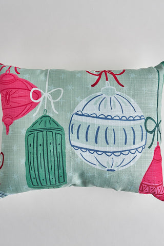 The Festive Ornament Pre-Filled Lumbar Pillow features a light green background with red, green, and white holiday ornaments hanging by ribbons—adding festive charm to any space.