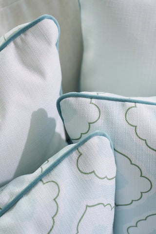 Close-up of decorative pillows from the Bee & Florals Collection: Victorian Tile Pillow by Sewing Down South, featuring a pastel cloud pattern and teal velvet welt. The pillows are stacked on a couch, evoking a soft and cozy Victorian elegance.