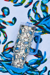 The Crab Craze 30oz Tumbler with a blue handle, straw, and blue crab pattern from Sewing Down South sits on a matching vibrant towel.