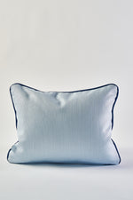 The Mod Flora Lumbar Pillow features a light blue rectangular design with a subtle textured pattern and dark blue piping, bringing modern Southern charm to any stylish space. Perfect as an accent pillow for your home décor.