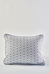 The Mod Mini Crossing Tiles Lumbar Pillow features a white background with a subtle gray grid and small blue dots at each intersection, plus dark piping—perfect for adding Southern style to your space.