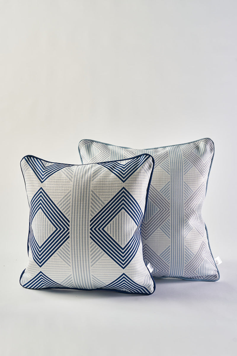 The Mod Geo Diamond in Navy Pillow features bold geometric diamonds in blue and white, adding Southern aesthetic decor to any space when paired with a navy pillow featuring a subtle linear pattern.