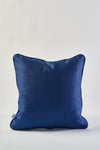 The Mod Geo Diamond in Navy Pillow, featuring a subtle textured pattern and square shape, is shown against a plain white background with a small white tag on its left side.