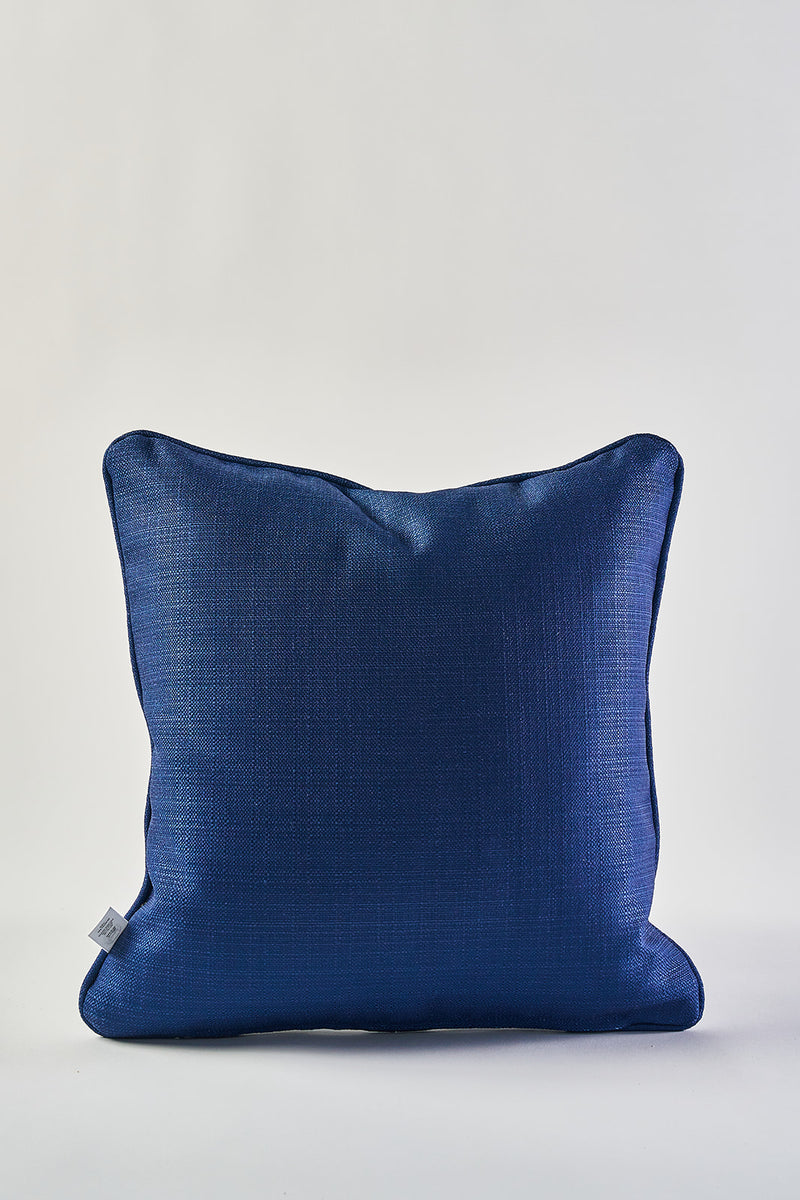 The Mod Geo Diamond in Navy Pillow, featuring a subtle textured pattern and square shape, is shown against a plain white background with a small white tag on its left side.