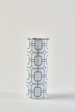 The Blue Lattice 20oz Tumbler, a tall stainless steel cup with a geometric blue and white pattern, silver rim, and no-sweat exterior, stands upright against a plain white background.