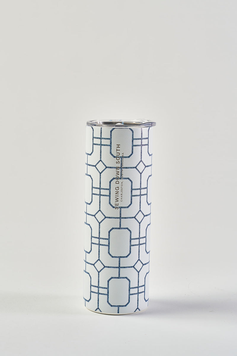 The Blue Lattice 20oz Tumbler, a tall stainless steel cup with a geometric blue and white pattern, silver rim, and no-sweat exterior, stands upright against a plain white background.