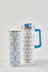 The Blue Lattice 20oz Tumbler is a white stainless steel cup with blue geometric patterns, a light blue lid, Sewing Down South branding, and a no sweat exterior. Tall and slim, it offers style and function.