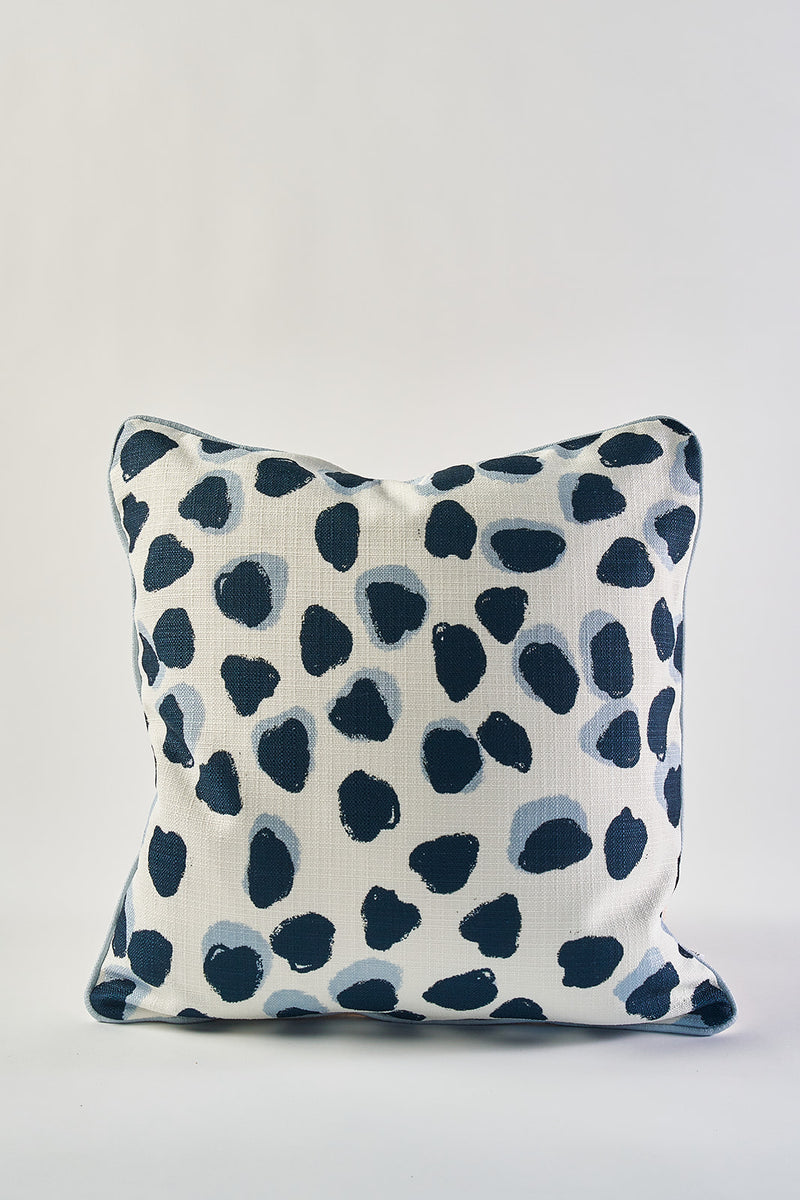 The Oversized Modern Polka Dots Pillow showcases a hand-painted pattern of irregular navy blue spots on white, blending abstract animal print style with southern decor—ideal for adding charm to any room.