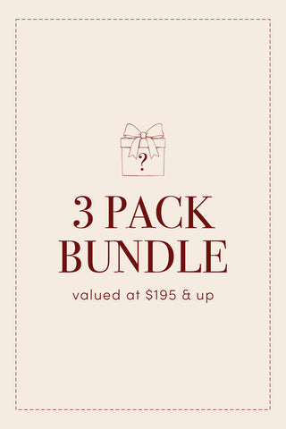 Illustration of a gift box above the text "3-PACK Holiday Pillow Cover Mystery Bundle valued at $195 & up" on a beige background with dashed border lines, perfect for featuring your Christmas pillow covers or a festive mystery bundle.