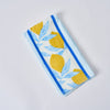 The Lemons in a Line Kitchen Towels, 2 pack features 100% cotton tea towels with a Sewing Down South pattern on a light blue background, showcasing vibrant yellow lemons and leaves bordered by blue stripes on a white surface.