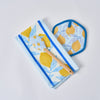 The Lemon Kitchen Bundle includes a 100% cotton towel, pot holder, and spatula—all showcasing matching blue and yellow lemon designs—arranged on a white background.