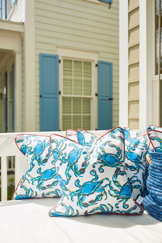 Crab Craze, Shades of Blue Outdoor Pillow features a charming crab print and enhances your patio bench against a house with light blue shutters and siding. Made with SDS Shield® Outdoor Fabric, these pillows offer style and durability to your outdoor space.