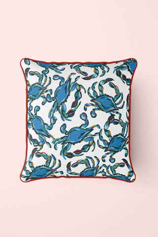 The Crab Craze, Shades of Blues Pillow features a lively crab print on white with red piping, embodying coastal flair. Blue crabs are dynamically arranged in various directions, designed by Sewing Down South.