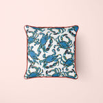 The Crab Craze, Shades of Blues Pillow features a lively crab print on white with red piping, embodying coastal flair. Blue crabs are dynamically arranged in various directions, designed by Sewing Down South.