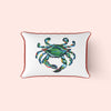 The King Crab Lumbar Pillow displays a vibrant King Crab print on a light pink background, with the crabs blue, green, and orange hues framed by a thin red outline, embodying Sewing Down Souths signature style.