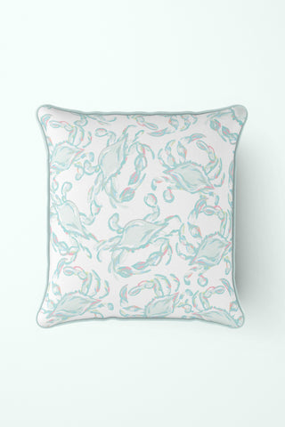 The Pastel Crab Craze Outdoor Pillow, a square white pillow with the Sewing Down South™ design, features a light blue and pink crab pattern. Made with durable SDS Shield® Outdoor Fabric, its perfect for marine-themed decor and serves as an ideal outdoor pillow against any backdrop.